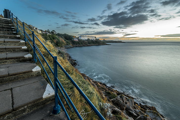 gray stairs pavement with black metal railings near sea, sorrento, killiney, dublin, ireland, sorrento, killiney, dublin, ireland