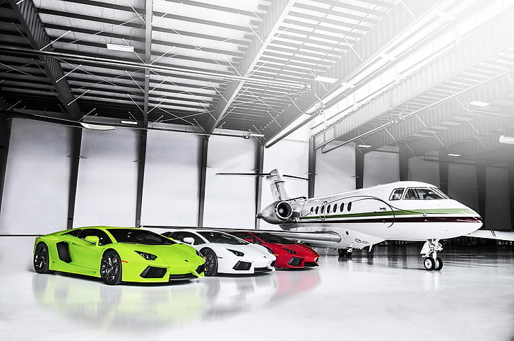 three white, green, and red Lamborghini Huracans and white private jet