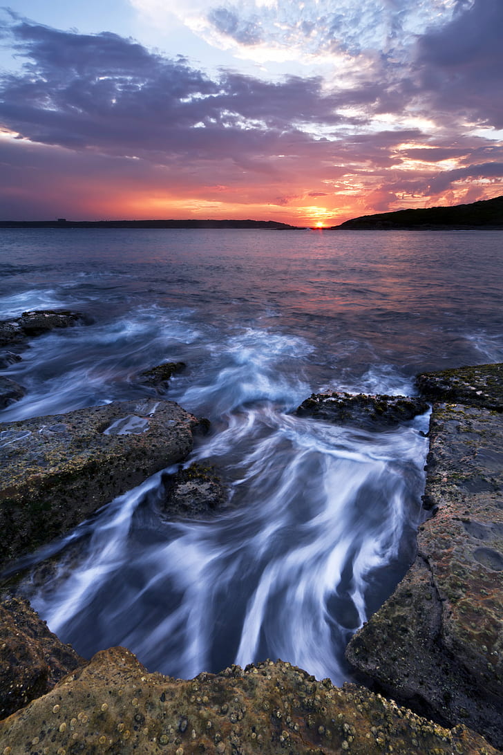 gray rocks near body of water during golden hour, la perouse, la perouse