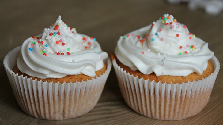two brown cupcakes with white icings and sprinkles, food, sweet food
