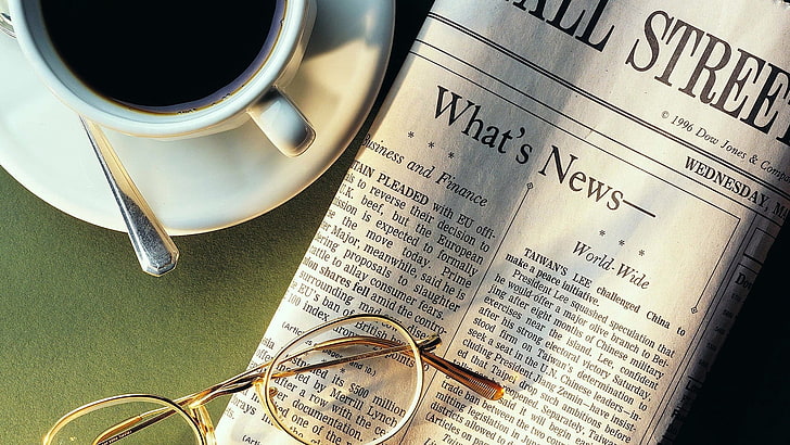 eyeglasses with gold frames, newspaper, coffee, cup, spoon, sunglasses