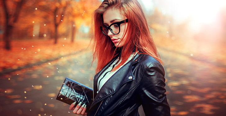 women's black leather jacket, woman wearing black leather jacket with red blond hair holding a wallet