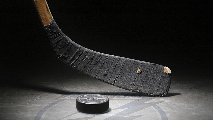 black hockey stick and puck, ice hockey, indoors, studio shot