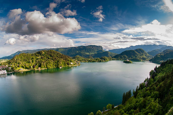 aerial view of lake surrounded by green mountains during daytime, lake bled, lake bled