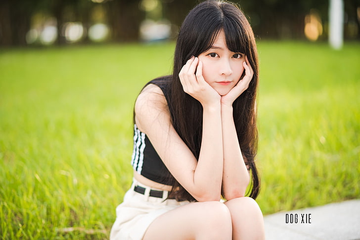 Asian, women, brunette, one person, grass, sitting, looking at camera