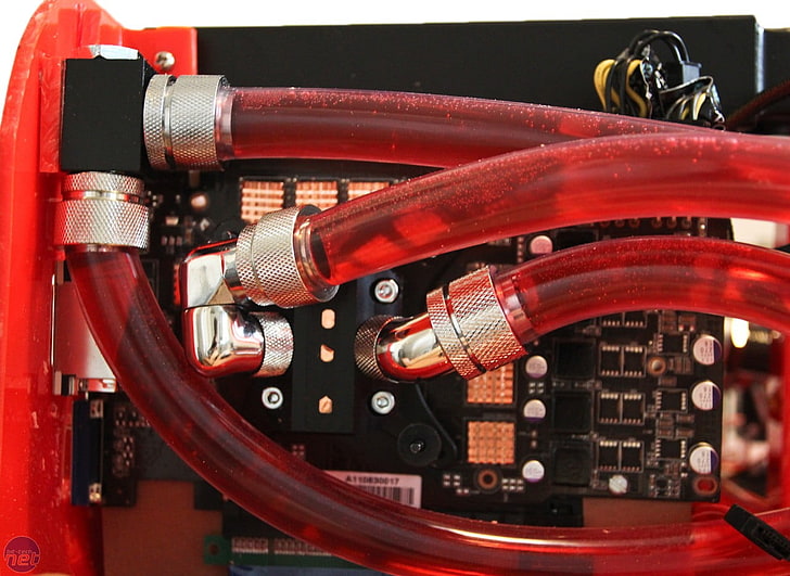black PCB board with red cable attachments, computer, close-up