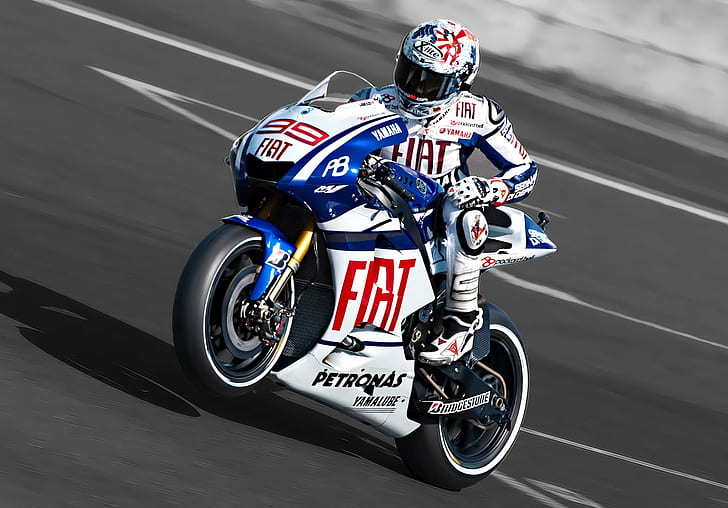 rider on a white and blue FIAT motorcycle on a concrete track