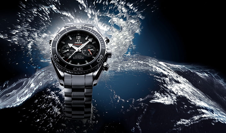 round black and silver-colored Omega chronograph watch, water