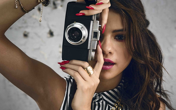 woman holding black and silver SLR camera, Selena Gomez, women