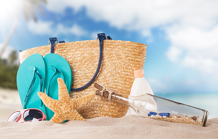 brown wicker shoulder bag and teal flip-flops, sand, beach, bottle