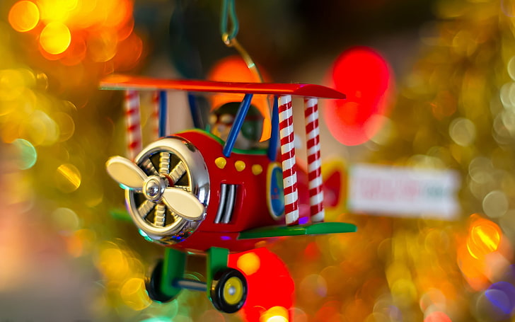 red and silver biplane toy, Christmas, focus on foreground, close-up