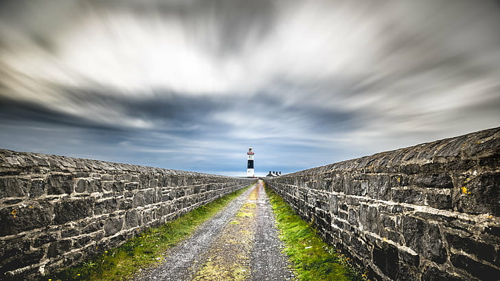 timelapse photography of pathway in between concrete walls and lighthouse range view, ireland, ireland