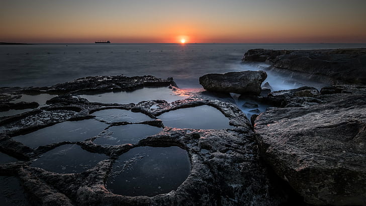 close up photo of black rock formation beside sea during golden hour, marsaskala, malta, marsaskala, malta