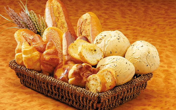 basket of baked breads, pastries, muffins, slices, loaves, buns