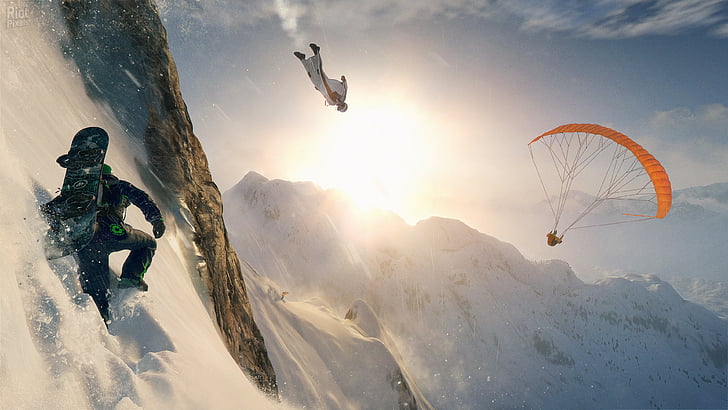three person climbing on the snow covered cliff, diving, and paragliding