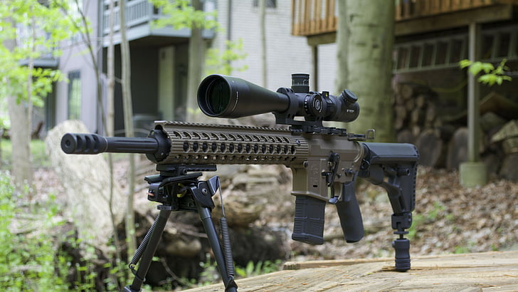 photograph of gray and black scoped rifle, AR-15, custom, semi-automatic