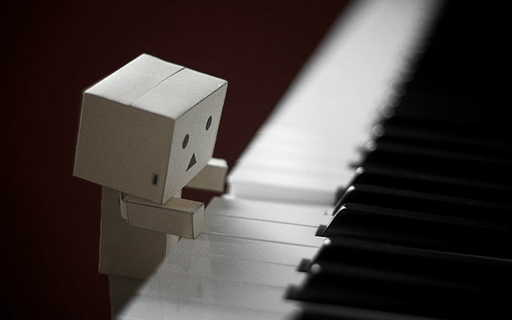 box human figure playing piano, danboard, cardboard robot, keys