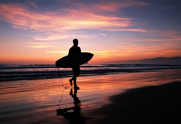 person holding surfboard while walking in the beach at night time, los angeles, los angeles, HD wallpaper