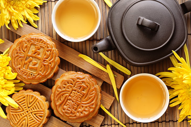 moon cake and tea beside black kettle, flowers, cookies, the tea party