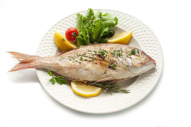 cooked fish with vegetable, dish, herbs, lemon, white background