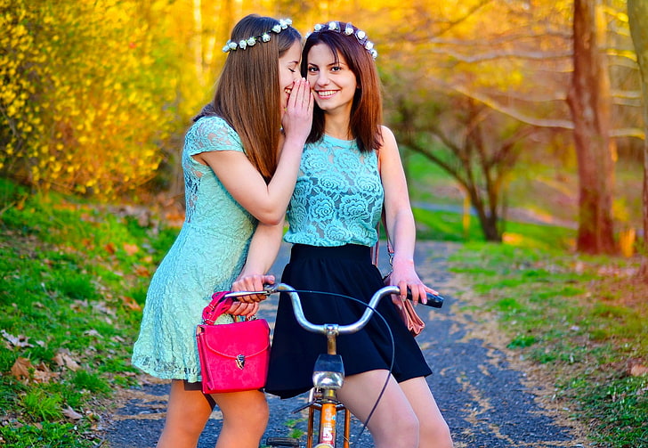 woman wearing teal cap sleeve whispering woman on riding bicycle, HD wallpaper