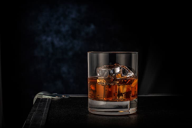 glass, ice, whiskey, the dark background