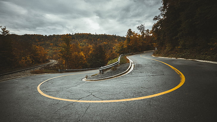 winding road, shallow focus photography of a concrete road, hairpin turns