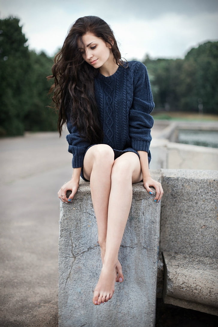women's blue sweater, smiling, barefoot, brunette, legs, black sweater