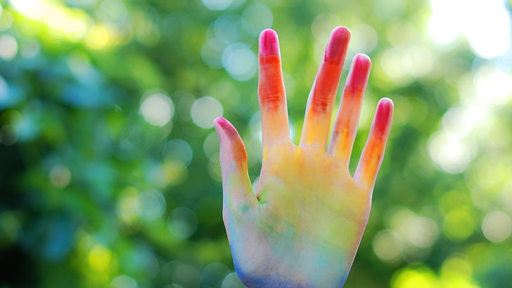 left human palm, colorful, hands, close-up, focus on foreground