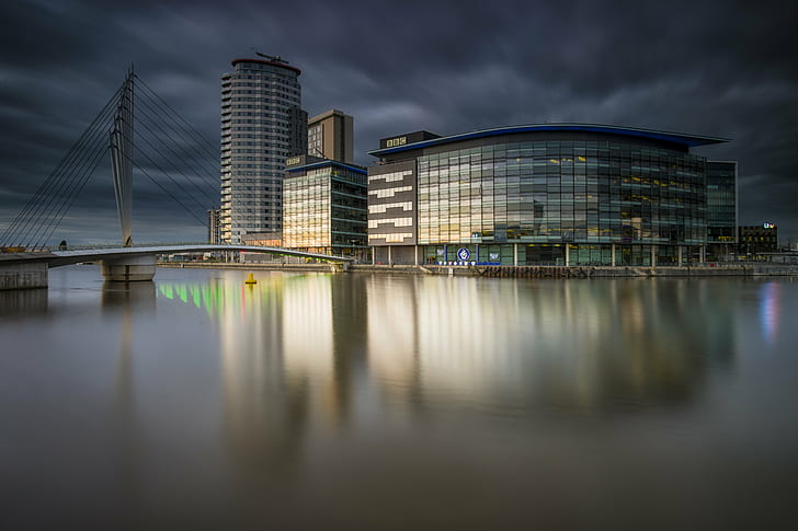 gray and white glass wall building near body of water and bridge, salford quays, salford quays