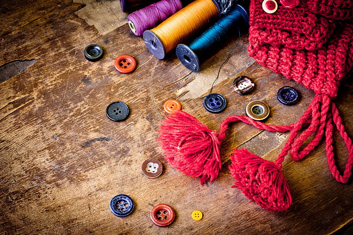 assorted-color threads, symbolism, sewing, buttons, wooden background