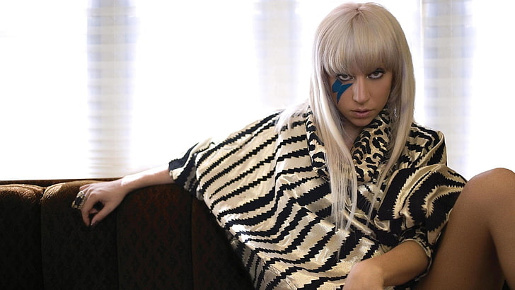 Lady Gaga, face paint, sitting, ponchos, blond hair, one person