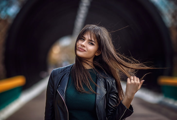 women outdoors, long hair, leather jackets, touching hair, holding hair