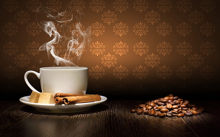white ceramic teacup and coffee bean lot, steam, cinnamon, sugar