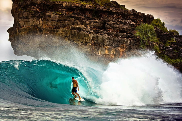 Surfing on wave, men's black shorts, surfer