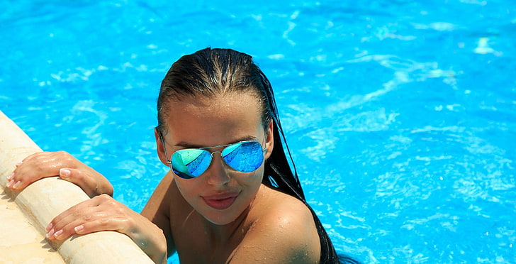 woman wearing black framed aviator-style sunglasses in swimming pool
