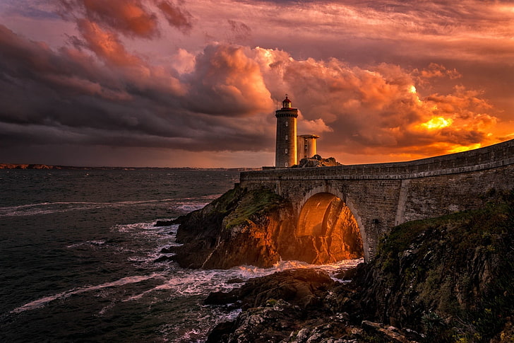 lighthouse on cliff with brown concrete bridge during golden hour, HD wallpaper