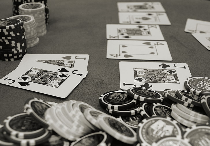 grayscale photography of poker chips and playing cards, grey
