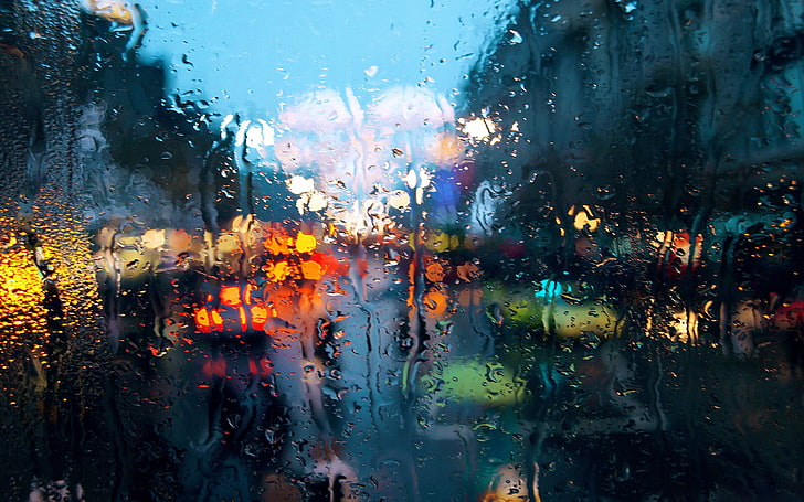 clear glass panel, rain, cityscape, water on glass, bokeh, abstract