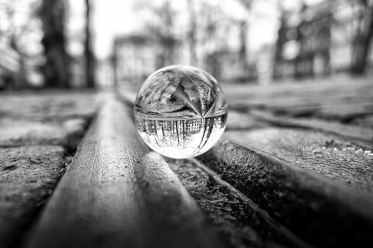 grayscale photography of glass ball on canal, Shot, through glass