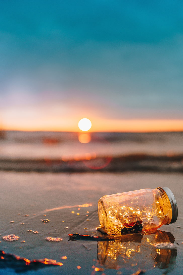 clear glass jar with lid, bank, sea, sunset, glitter, blur, sky