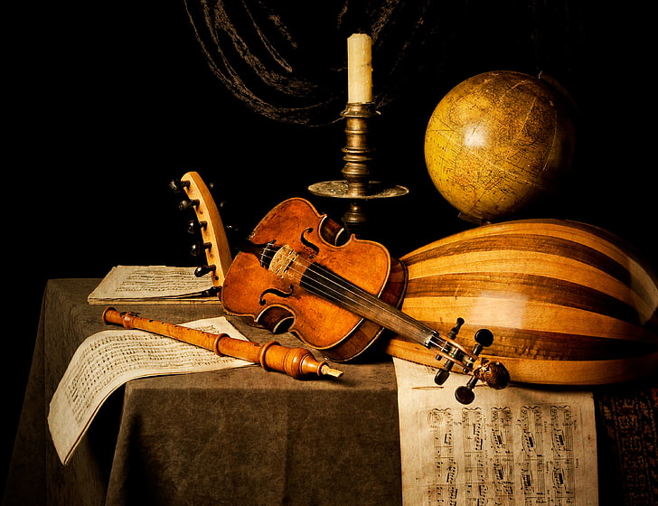 several instruments, notes, table, violin, candle, flute, globe