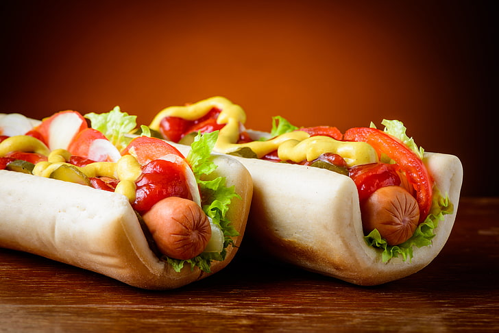 two hotdog sanwiches, greens, sausage, vegetables, sandwiches