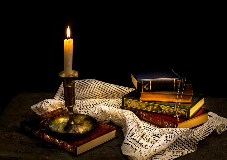 brass-colored candlestick holder, books, wax, cross, Still life¬