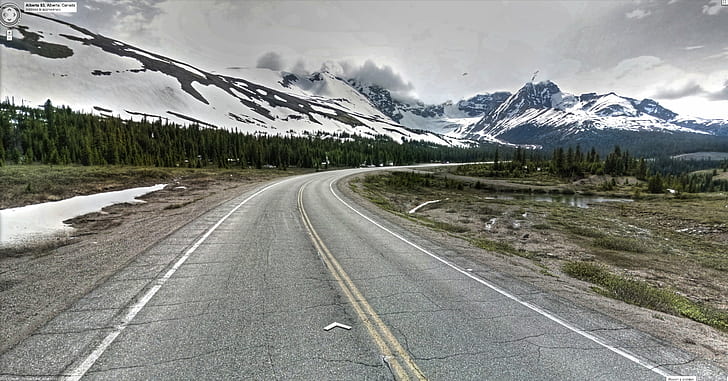 road near snow covered mountains and tress, Google Street View