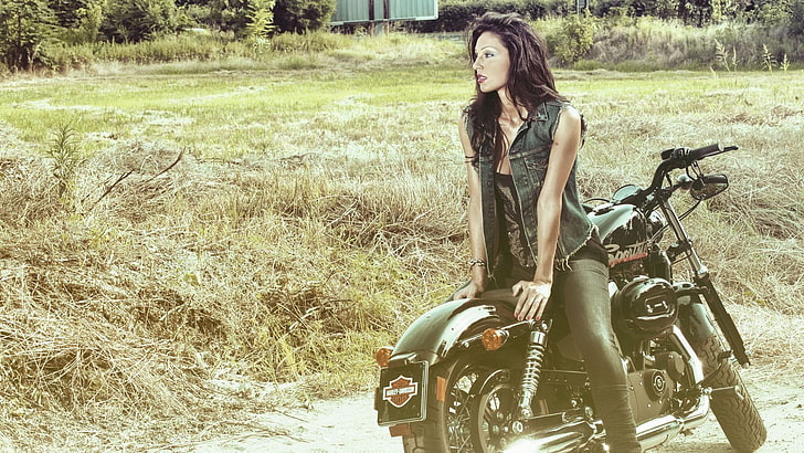 black touring motorcycle, women, dark hair, red lipstick, Harley Davidson