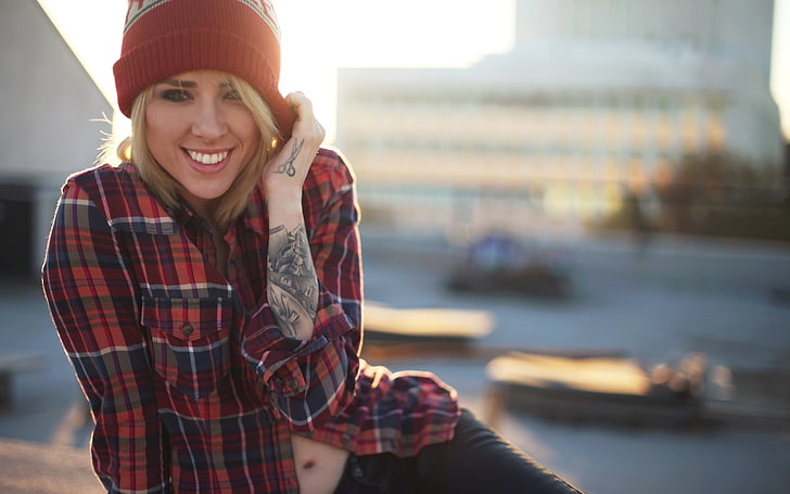 woman wearing red and white plaid dress shirt and red knit cap