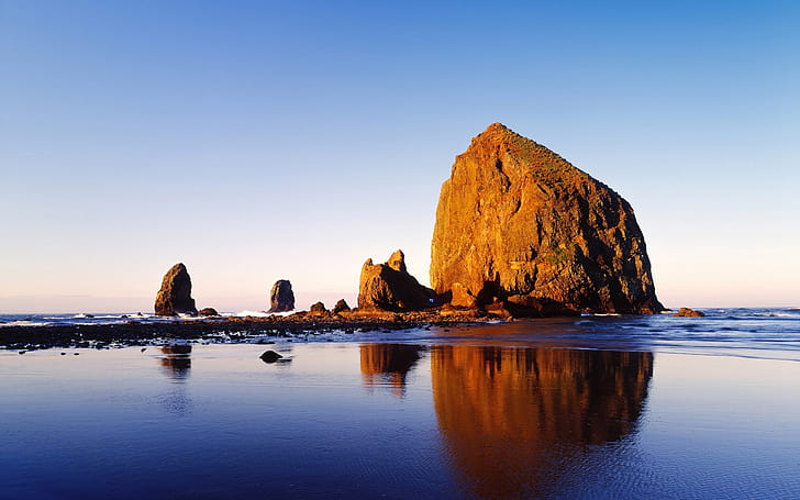 Cannon Beach, Oregon, USA, brown rock formation on body of water