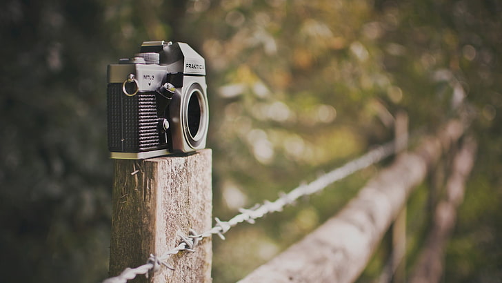 black and gray SLR camera, barbed wire, fence, bokeh, depth of field