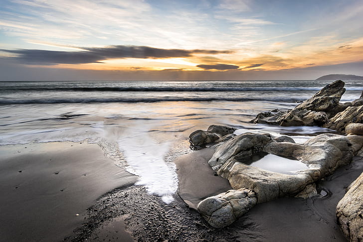 photo of a seashore with rocks during sunset, white rock, dalkey, ireland, white rock, dalkey, ireland